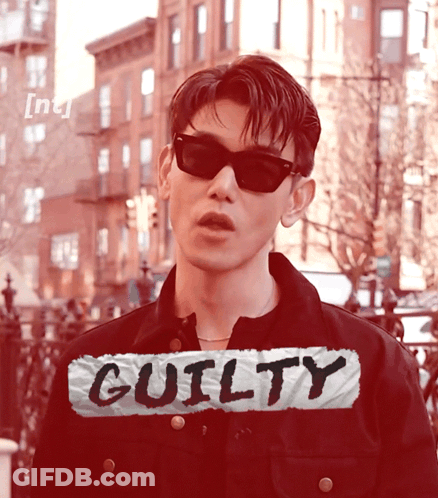 Man In Sunglasses In Front Of Guilty Sign GIF