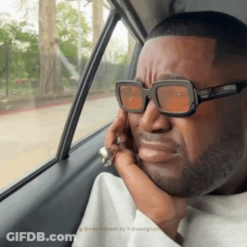 Man In Sunglasses Looking Out Car Window GIF