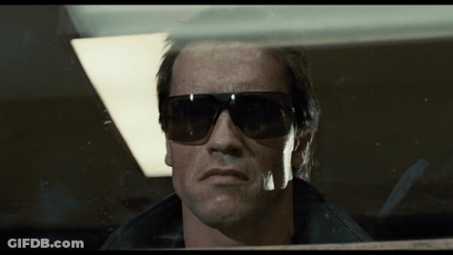 Man In Sunglasses Looking Through Window GIF