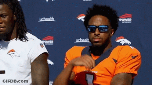 Man In Sunglasses Next To Man In Broncos Jersey GIF