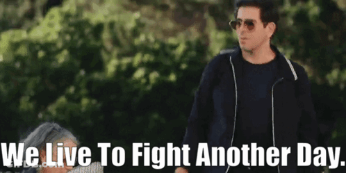 Man In Sunglasses Next To Woman We Live To Fight Another Day GIF
