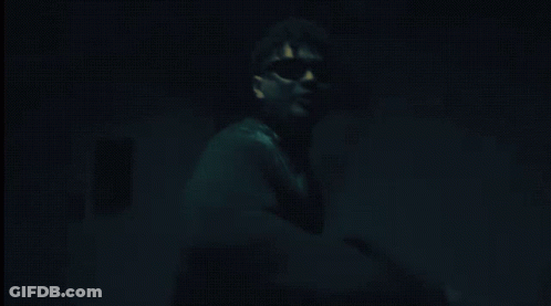 Man In Sunglasses Pointing In Dark GIF
