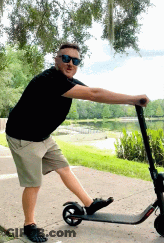 Man In Sunglasses Pushing Scooter GIF