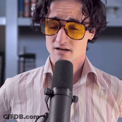 Man In Sunglasses Singing Into Microphone With Eyes Closed GIF
