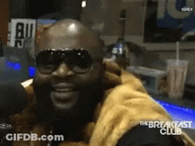 Man In Sunglasses Sitting At Microphone GIF