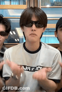 Man In Sunglasses Sitting At Table Hands In Air GIF