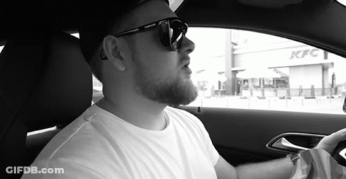 Man In Sunglasses Sitting In Car In Front Of KFC GIF