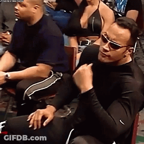 Man In Sunglasses Sitting In Chair Before Crowd GIF
