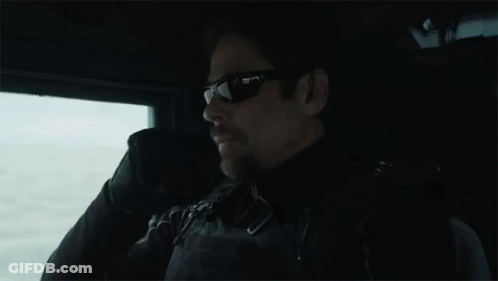Man In Sunglasses Sitting In Dark Room GIF