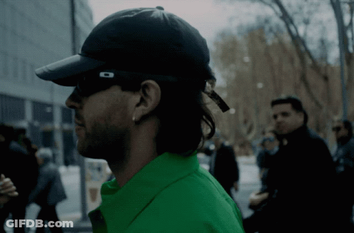 Man In Sunglasses Sitting In Dark Room GIF