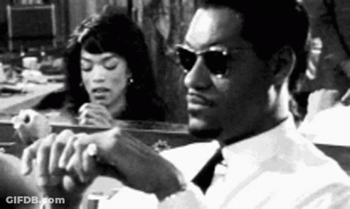 Man In Sunglasses Sitting In Front Of Mirror With Woman Looking GIF