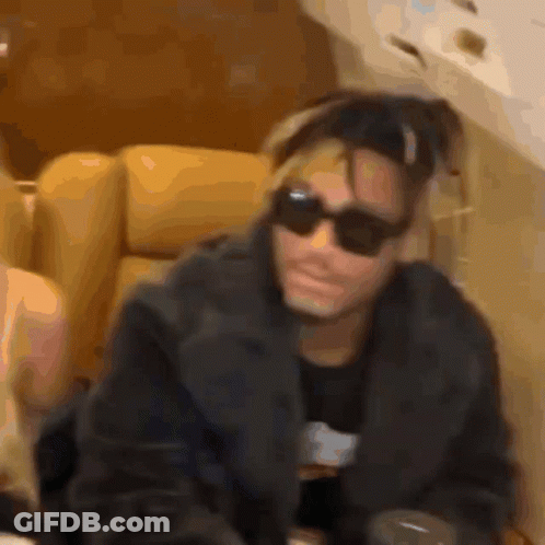 Man In Sunglasses Sitting On Couch GIF