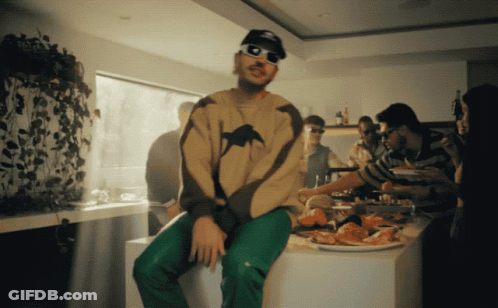 Man In Sunglasses Sitting On Counter With Food GIF
