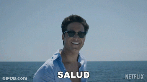 Man In Sunglasses Smiling At Ocean With Salud GIF