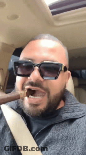 Man In Sunglasses Smoking Cigar In Car GIF
