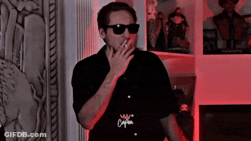 Man In Sunglasses Smoking Cigarette Shirt Says Caliban GIF