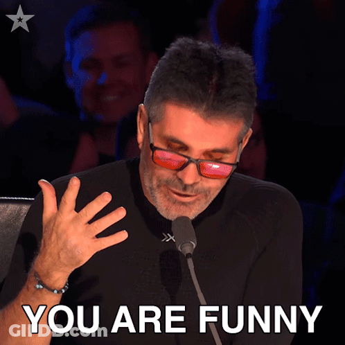 Man In Sunglasses Speaking Into Microphone Saying You Are Funny GIF
