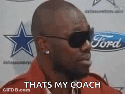 Man In Sunglasses Standing In Front Of Ford Logo GIF