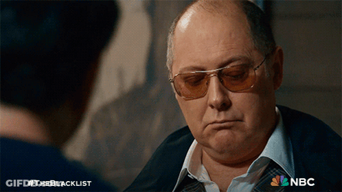 Man In Sunglasses Talking To Man With NBC Logo GIF