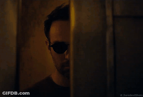 Man In Sunglasses Walking In Dark GIF