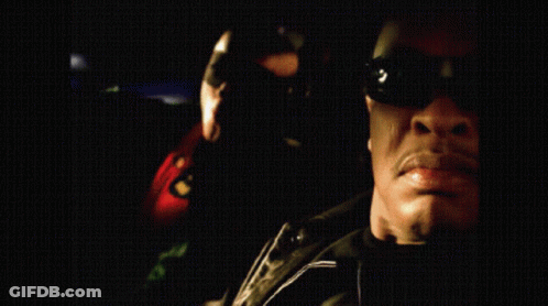 Man In Sunglasses With Woman In Green Hoodie GIF