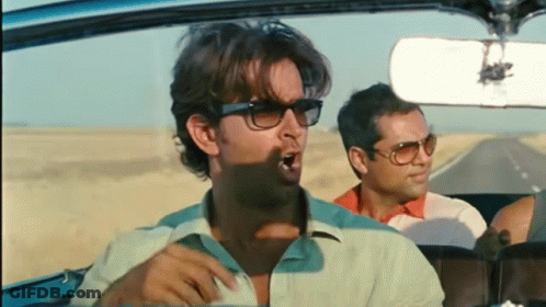 Man In Sunglasses Yawning In Car With Two Men GIF