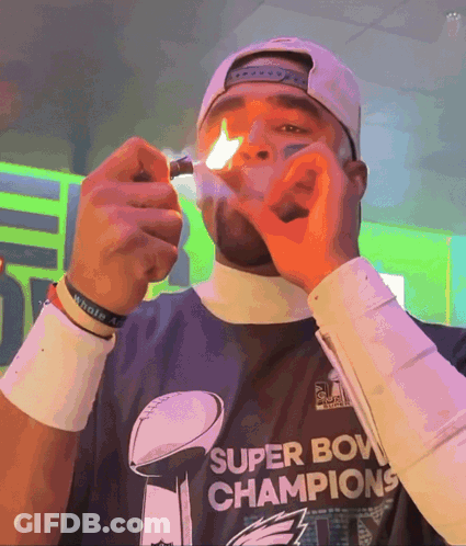 Man In Super Bowl Champions Shirt Lighting Cigarette GIF
