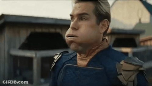 Man In Superhero Costume Blowing Bubble GIF