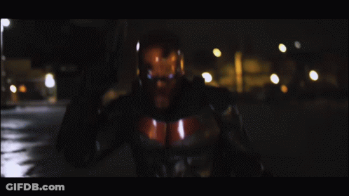 Man In Superhero Costume Holding Gun GIF