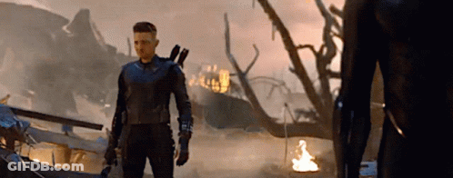 Man In Superhero Costume In Front Of Burning Building GIF