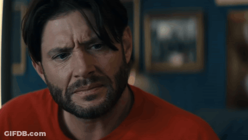 Man In Superhero Costume In Front Of Flag GIF