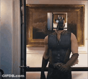 Man In Superhero Costume In Front Of Mirror GIF