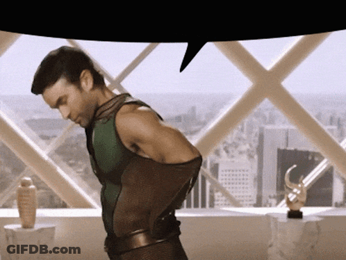 Man In Superhero Costume In Front Of Window GIF