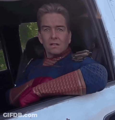 Man In Superhero Costume Looking Out Car Window GIF
