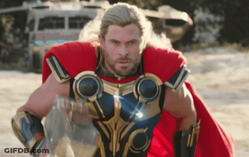 Man In Superhero Costume On Sand GIF