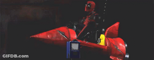 Man In Superhero Costume Riding Red Rocket GIF