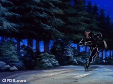 Man In Superhero Costume Running Through Snowy Forest GIF