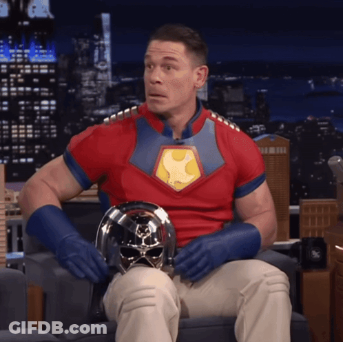 Man In Superhero Costume Sitting GIF