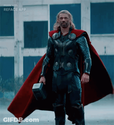 Man In Superhero Costume Standing In Sand GIF