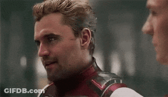 Man In Superhero Suit Talking To Another Man GIF