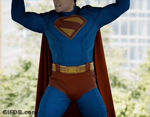 Man In Superman Costume Arms Up GIF