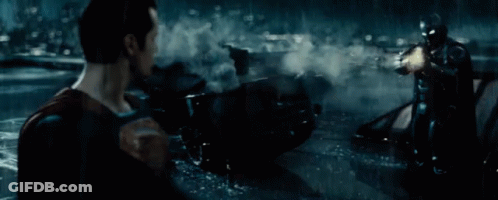 Man In Superman Costume Holding Gun In Water GIF