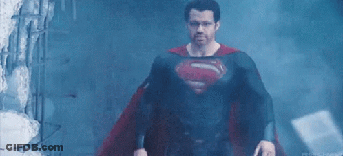 Man In Superman Costume In Dark Room GIF