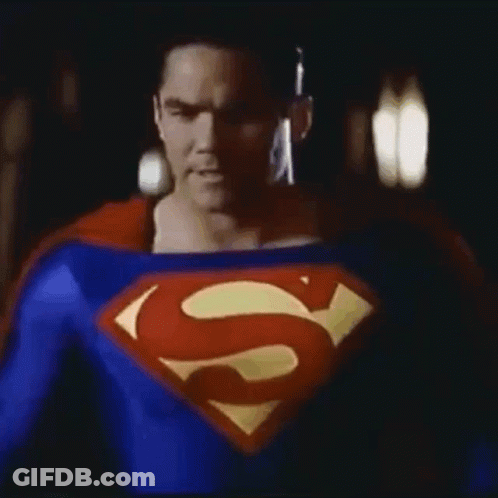 Man In Superman Costume In Dark GIF