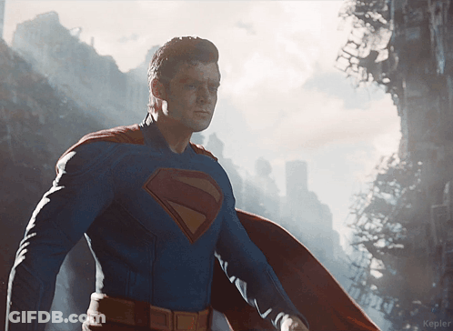 Man In Superman Costume In Front Of City GIF