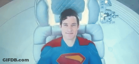 Man In Superman Costume Laying In Chair GIF