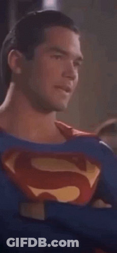 Man In Superman Costume Looking At Camera GIF