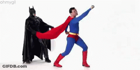 Man In Superman Costume Next To Batman GIF