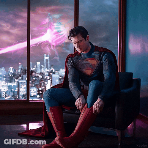 Man In Superman Costume Sitting On Chair GIF