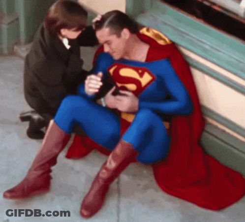 Man In Superman Costume Sitting On Ground GIF